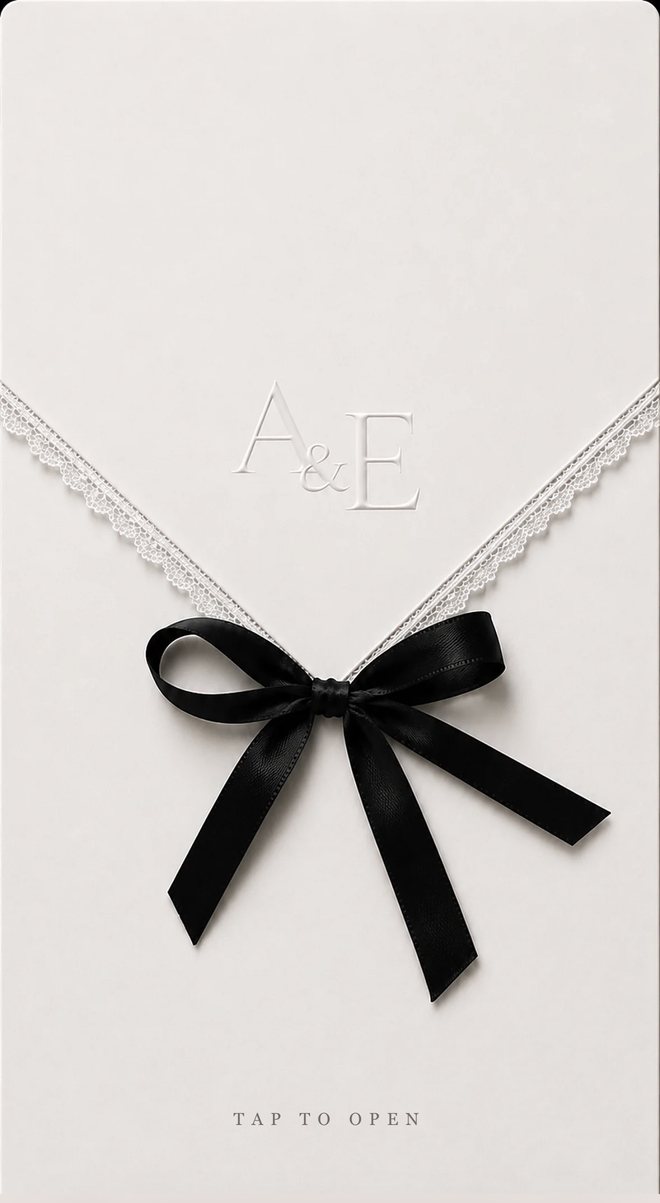 The envelope of a digital wedding invitation — ivory with a lace edge and black silk bow